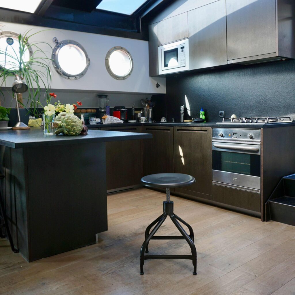 Adjustable metal stools in a kitchen by Chaises Nicolle